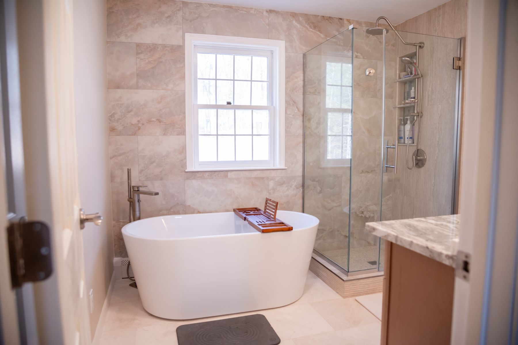 Freestanding tub and glass shower after a bathroom remodel