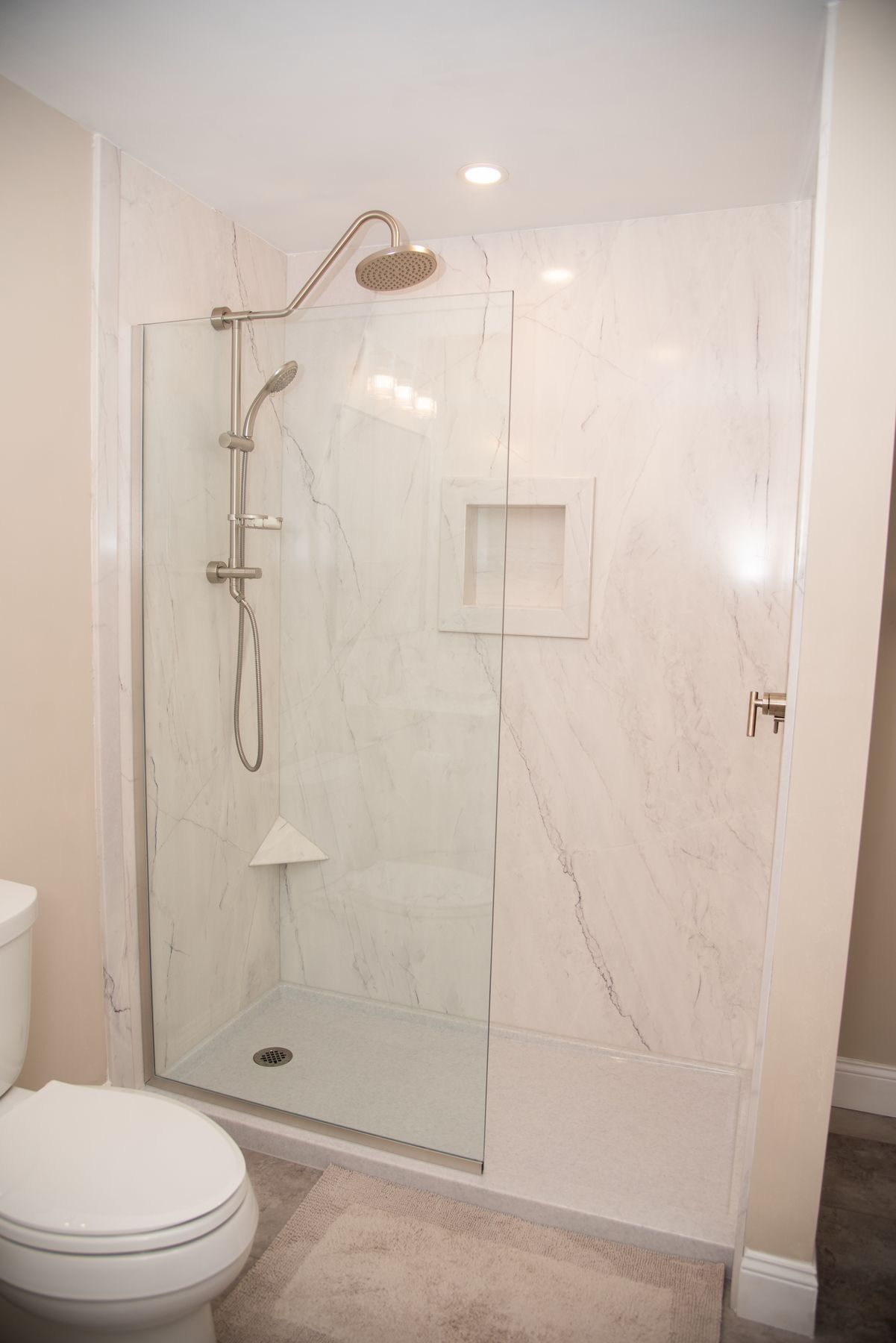 Walk-in shower with marble walls and rain head