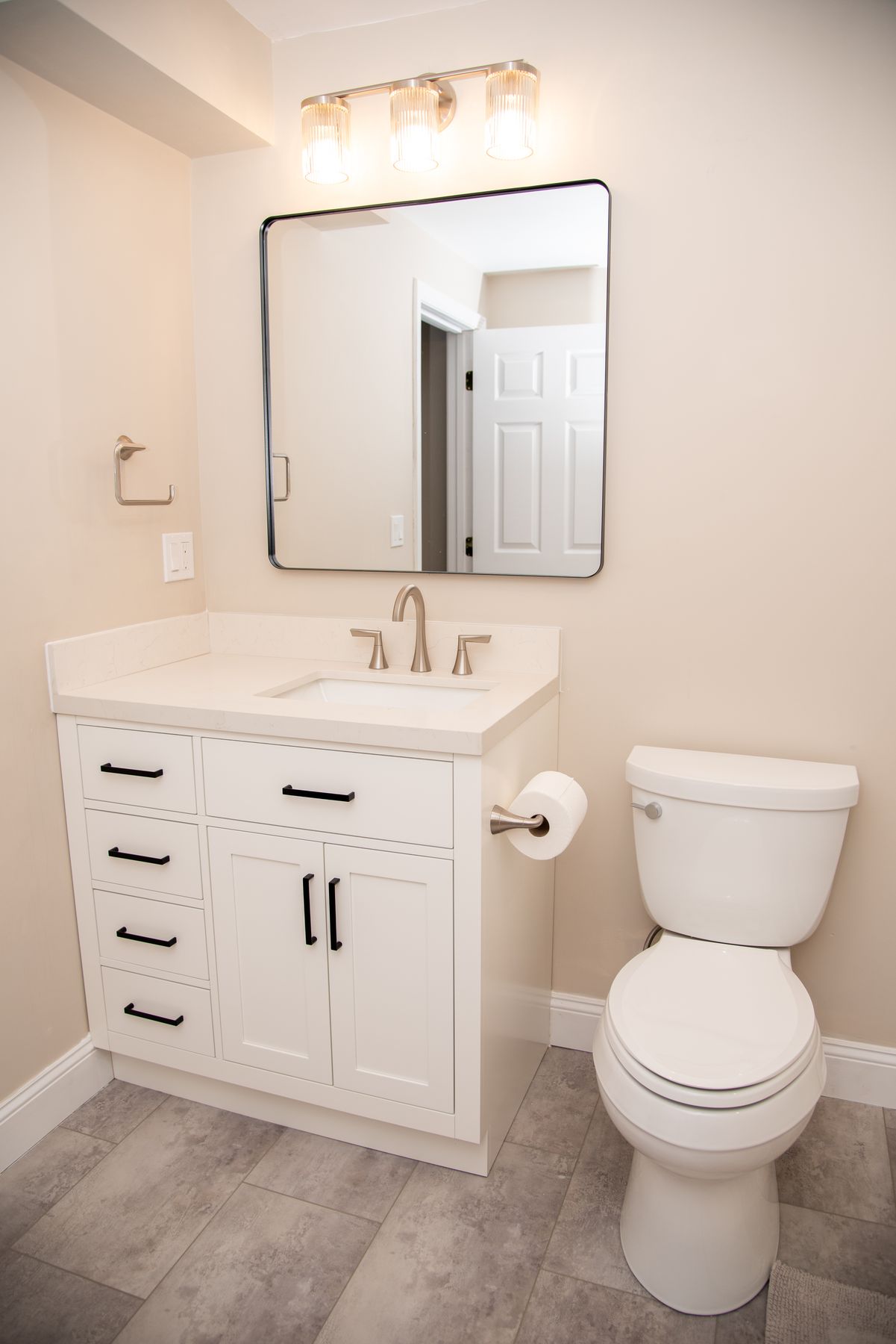 White vanity with quartz top and brushed nickel fixtures
