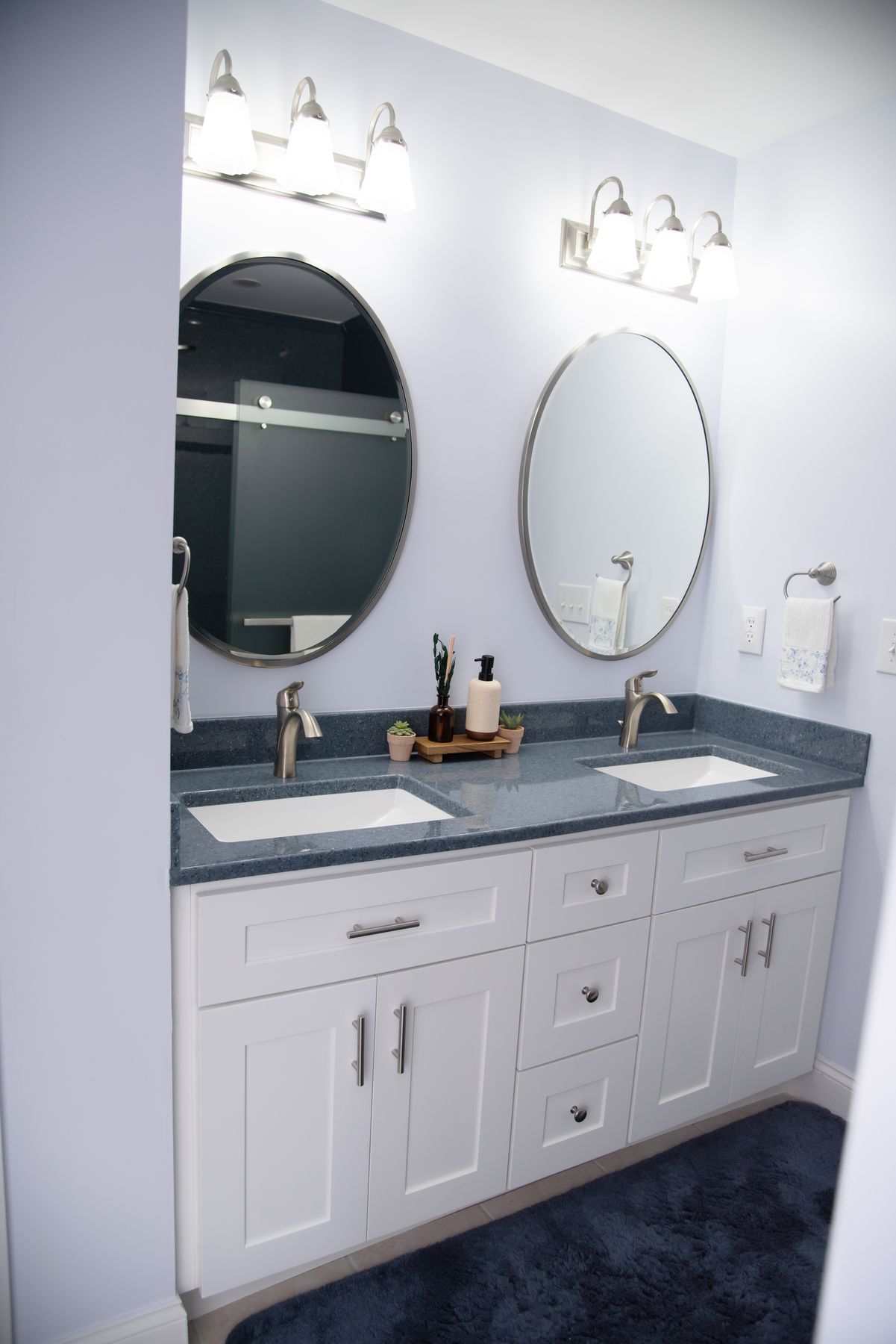White double vanity with oval mirrors