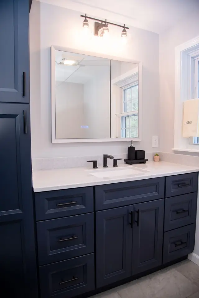 Navy vanity with quartz top and black fixtures