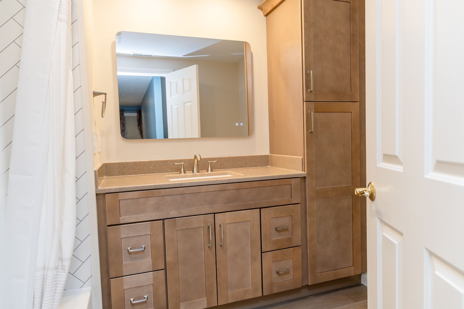 Maple vanity with a linen tower