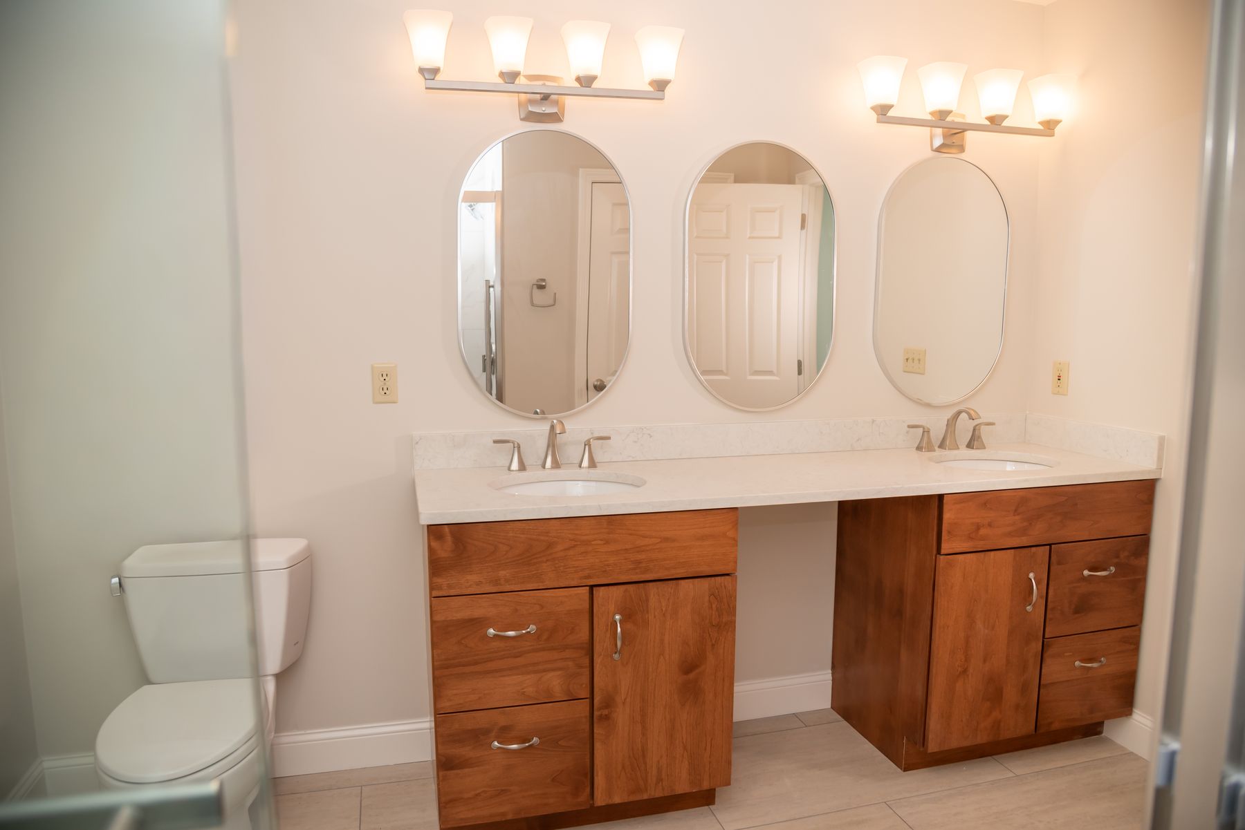 Double cherry vanity with oval mirrors