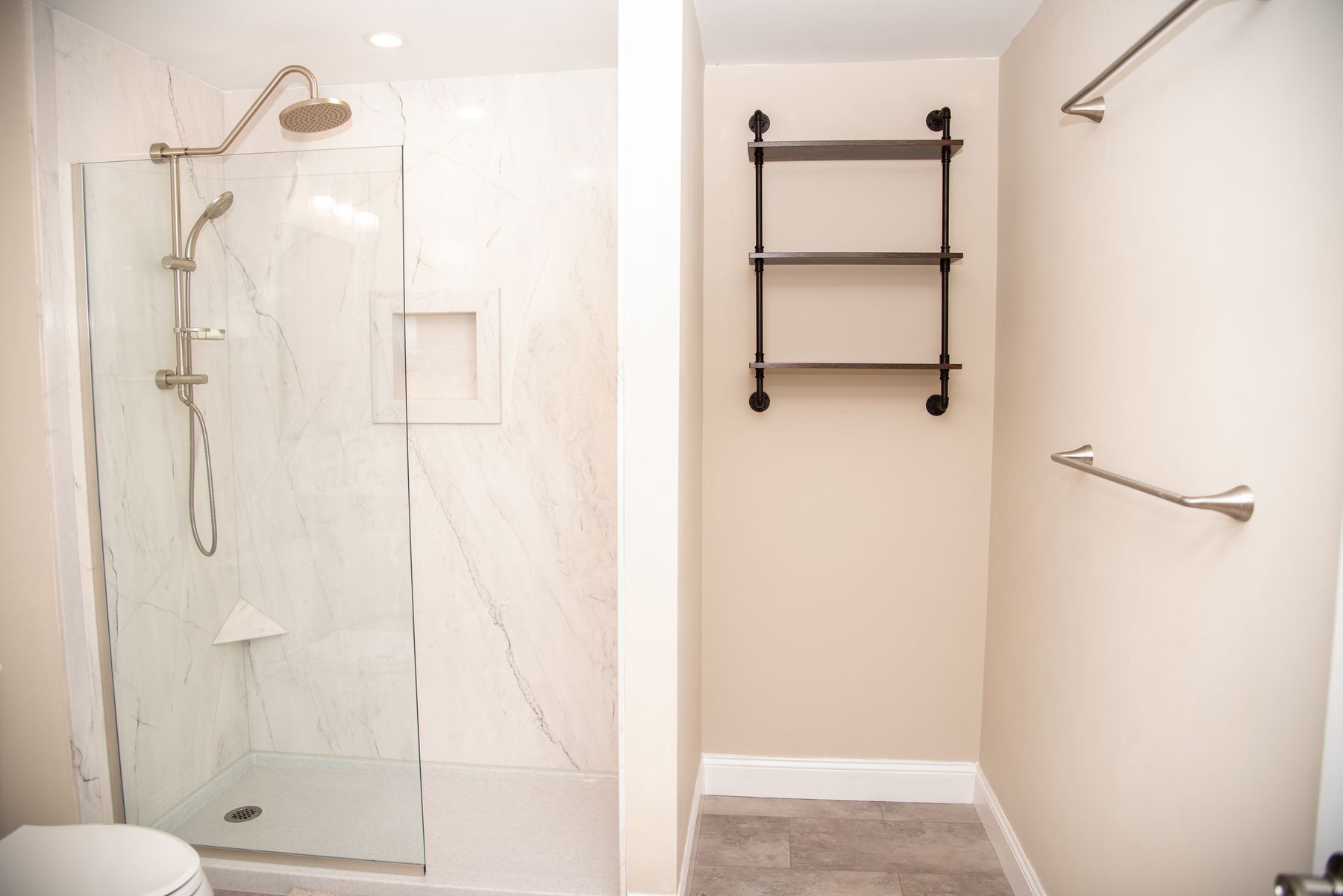 Walk-in shower next to a linen alcove