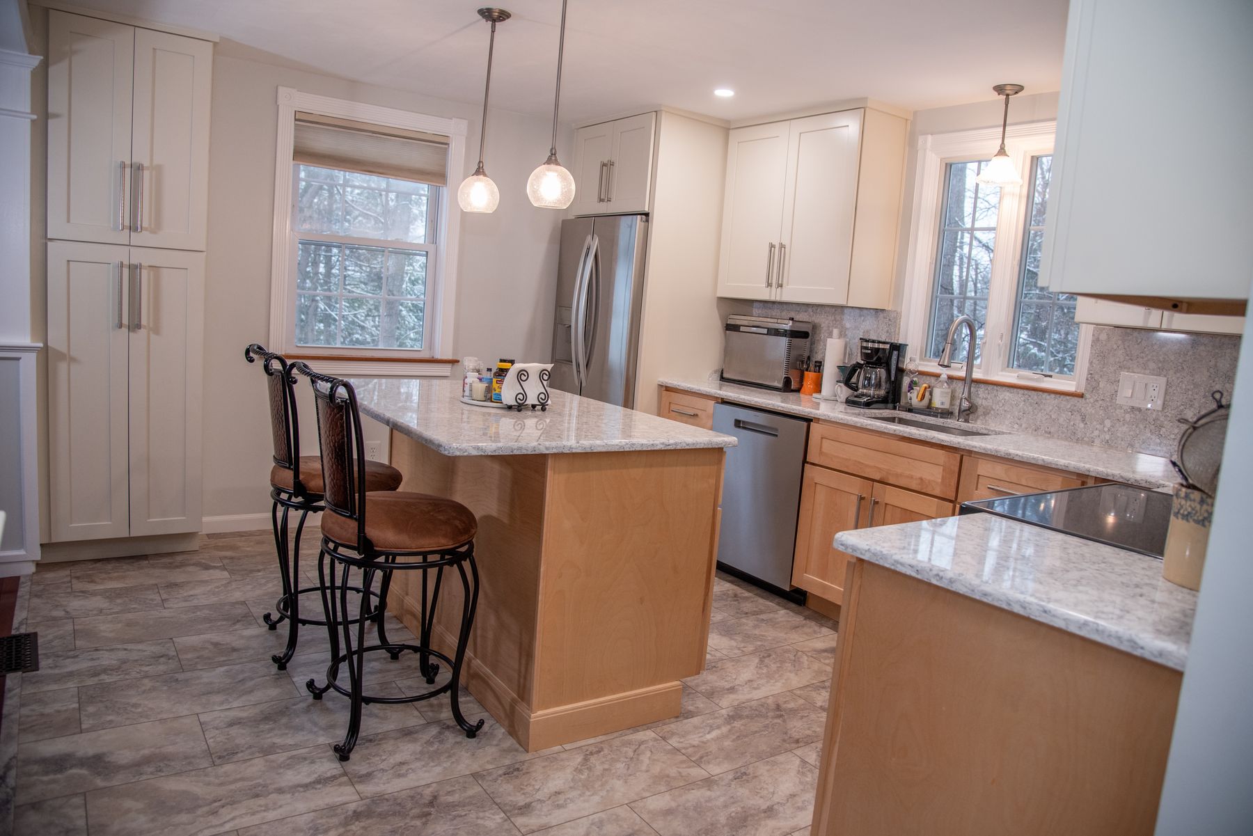 Kitchen remodel with maple cabinets, island and granite tops