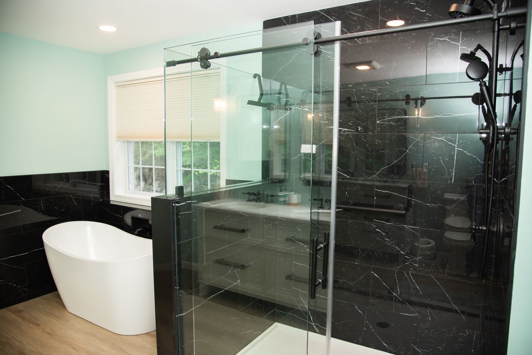 Sliding glass shower next to a freestanding tub